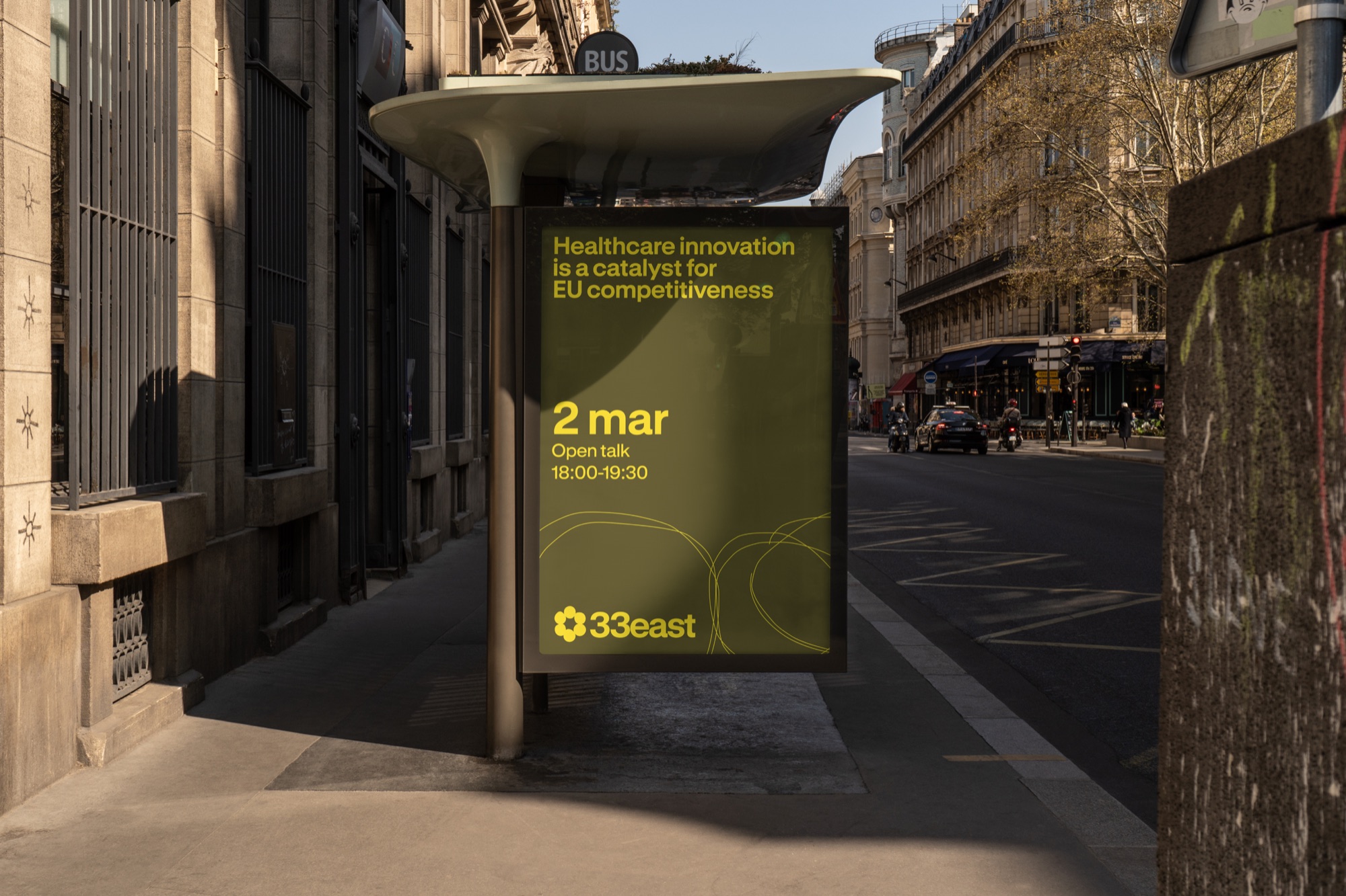 33east branded transit-shelter advertisement on a city street
