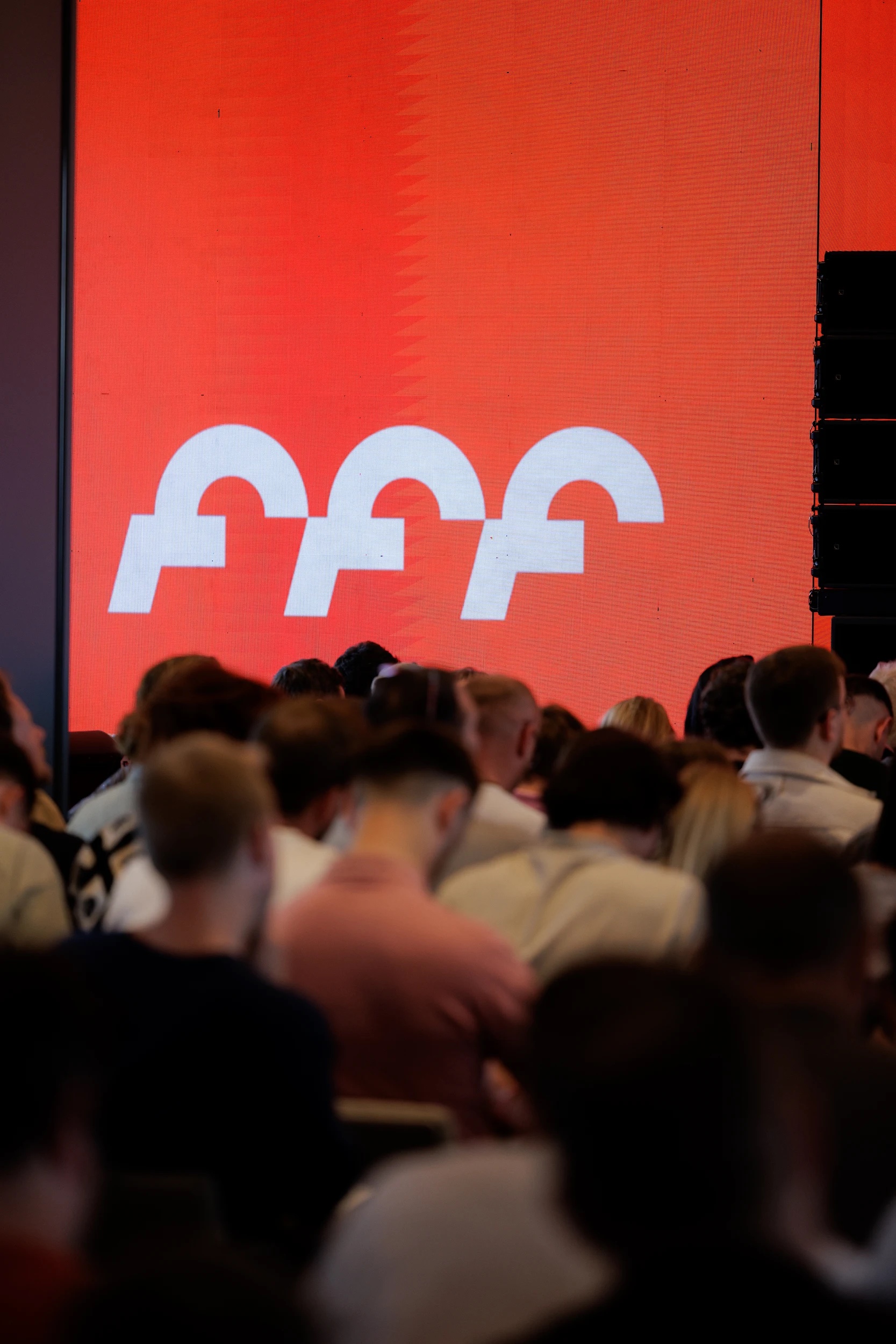 Founders for Founders conference stage with the FFF logo on a red LED wall above the audience
