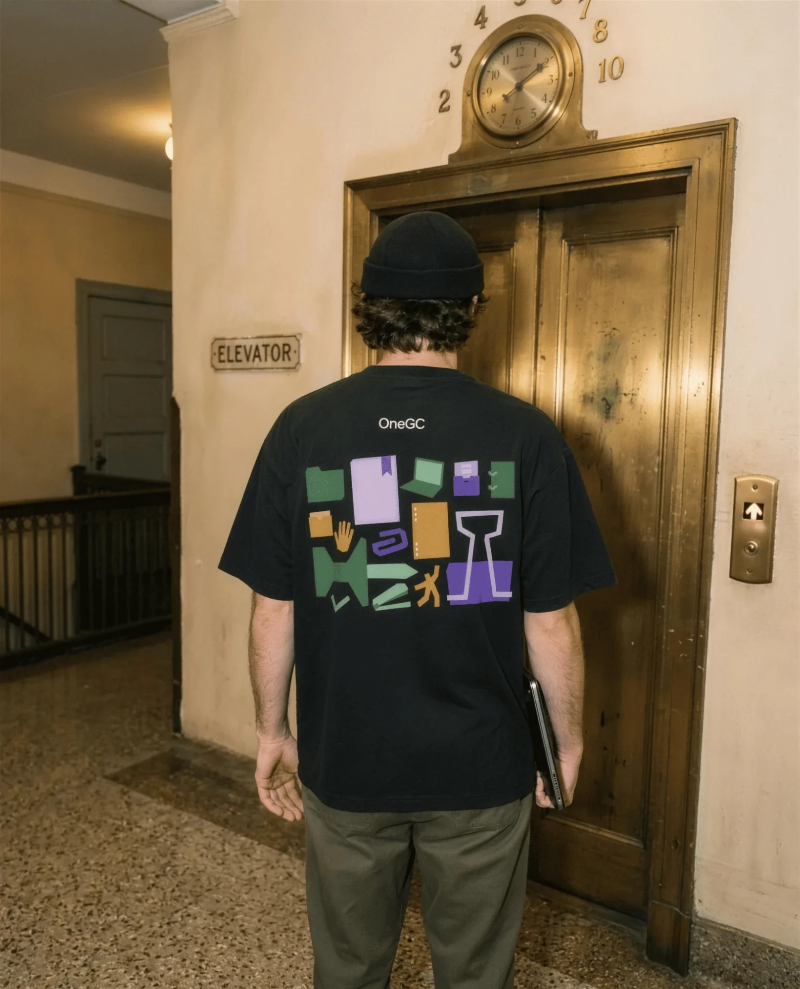 Black OneGC t-shirt with the papercut icon set on the back