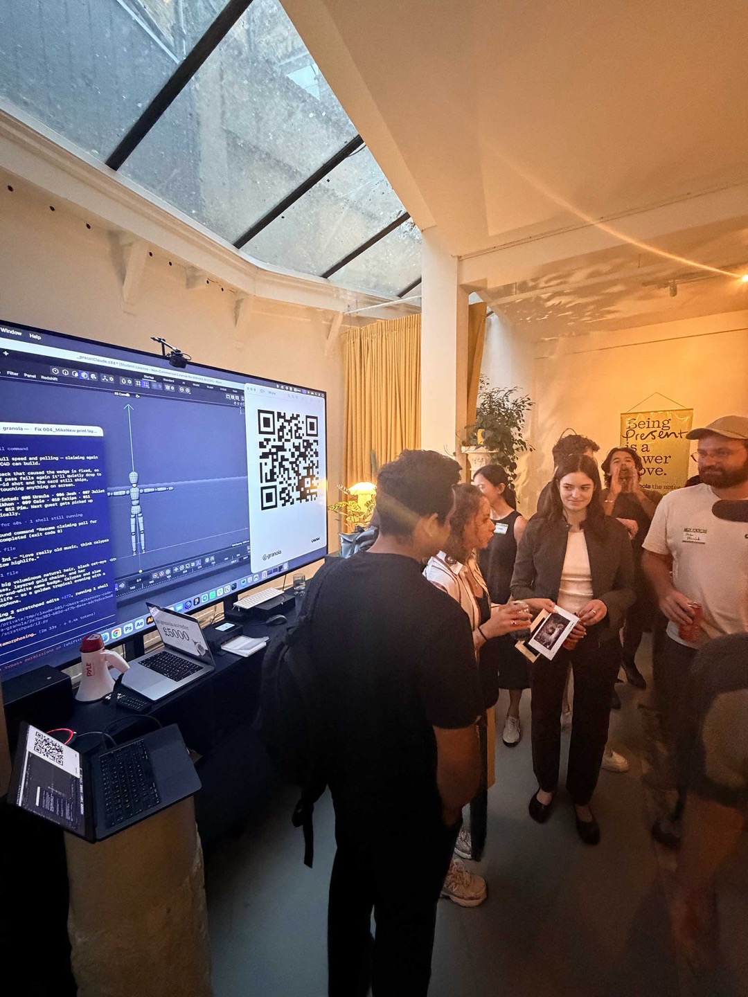 Guests around the big screen — Claude Code driving Cinema 4D live at the granola × UNKNW evening